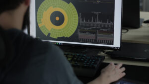 programmer looking at a computer screen with dashboards of managed services
