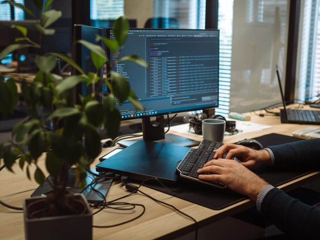 photo of a person's hands coding some enterprise software engineering service