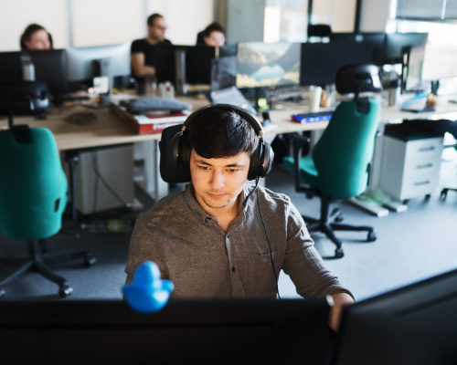 IT specialist working at a computer in an office environment, supporting disaster recovery plans.