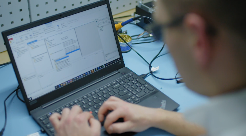 Engineer working on laptop software development for hardware.