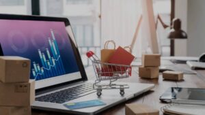 A laptop with a symbolic shopping cart on top. How to increase ecommerce conversion rate in your businesses
