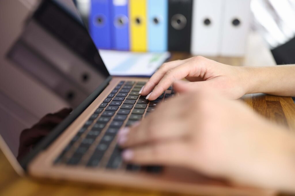 Cybersecurity specialist typing on a laptop during a penetration testing session – pentester working on system security assessment