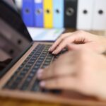 Cybersecurity specialist typing on a laptop during a penetration testing session – pentester working on system security assessment