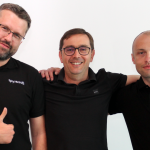 Three men in black Spyrosoft polo shirts, establishing Spyrosoft Connect.