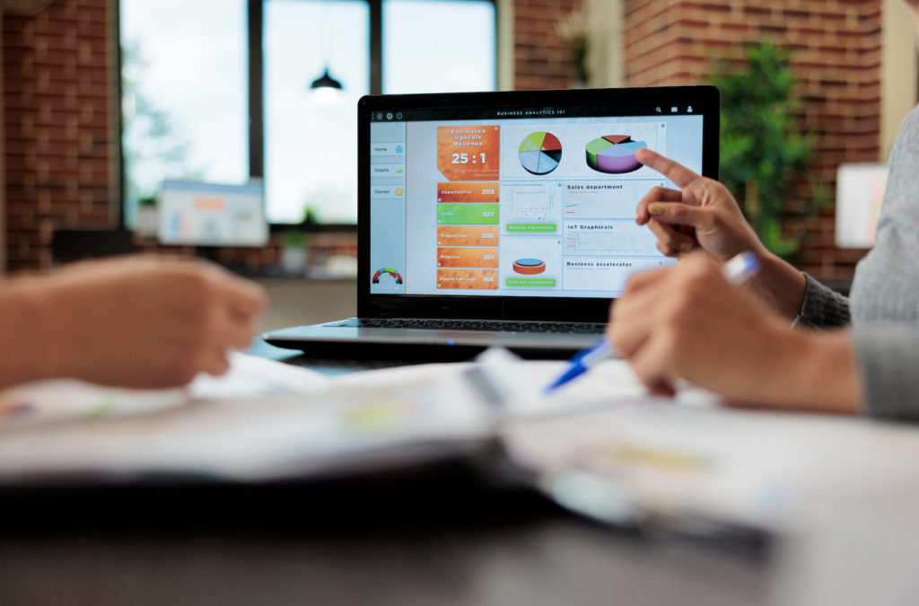 AI -  machine learning and data science - AI debt repayment prediction - two people looking on charts displayed on a laptop