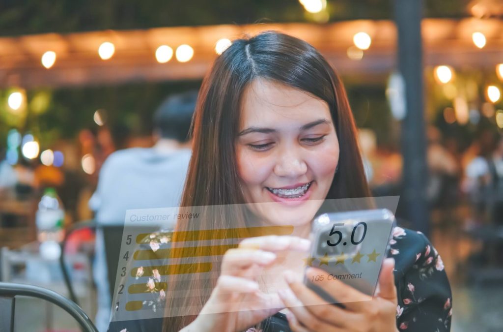 A woman with smartphone, rating customer satisfaction