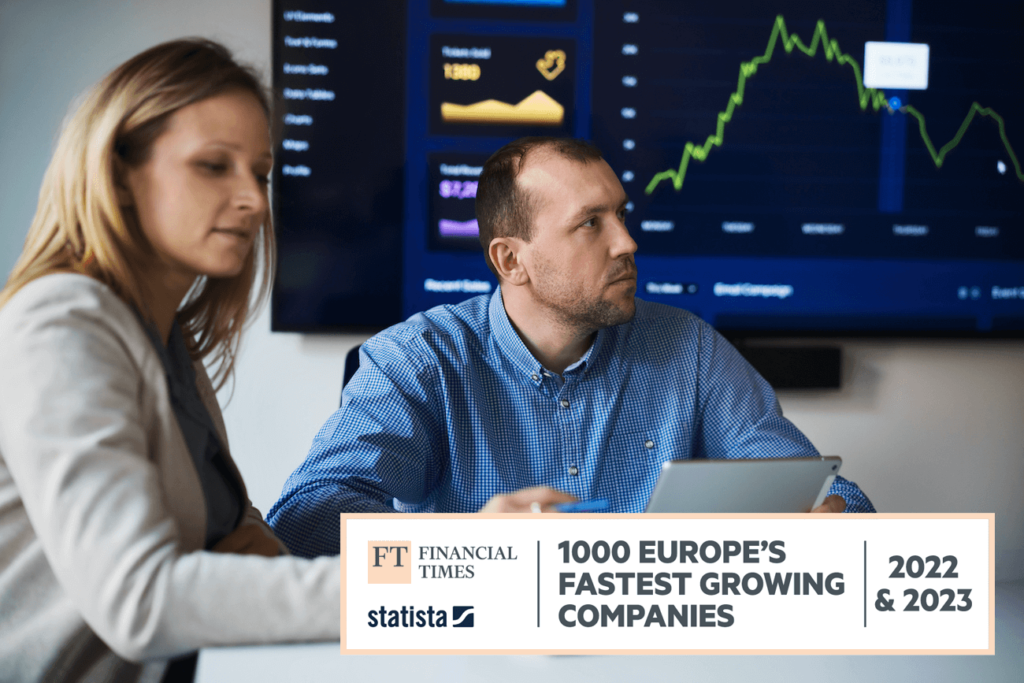 Employees of a listed company during a business meeting, with a monitor displaying stock market data in the background; the FT1000 award logo is included in the image.
