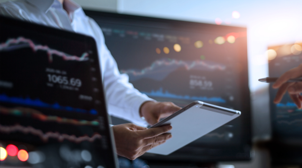 A financial specialist in front of displays with financial data