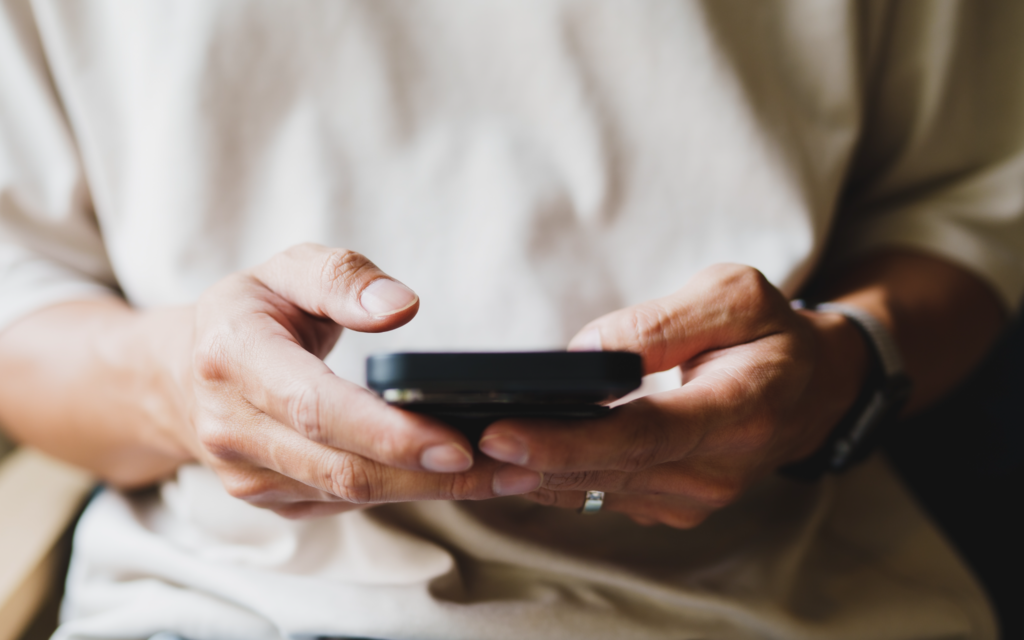 A shot of a person's hands scrolling a smartphone