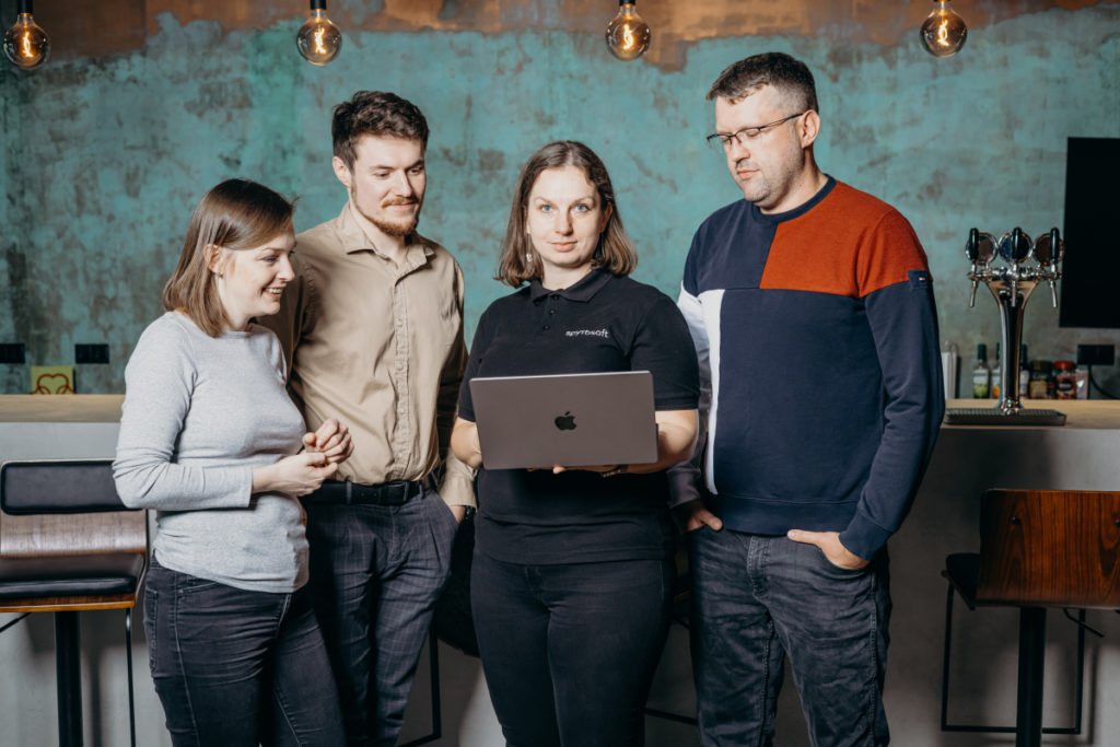 Four people of the Spyrosoft Connect team have a meeting about Salesforce add-ons.