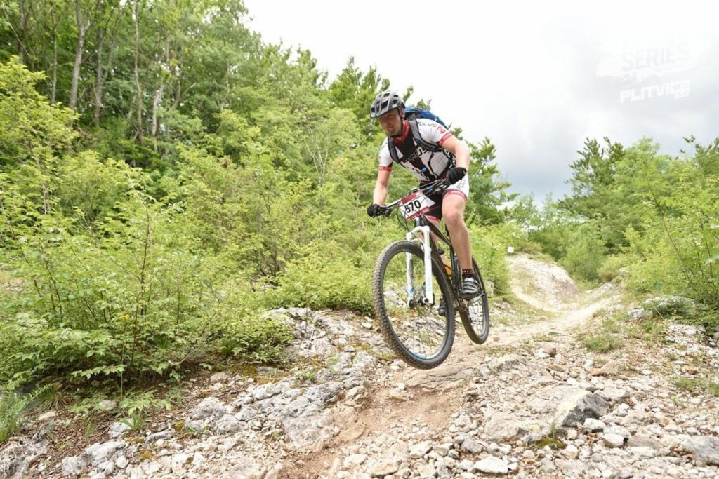 Mountain biking on uneven terrain as a metaphor for navigating complex systems engineering challenges.