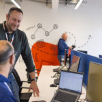 Men in front of a laptop.