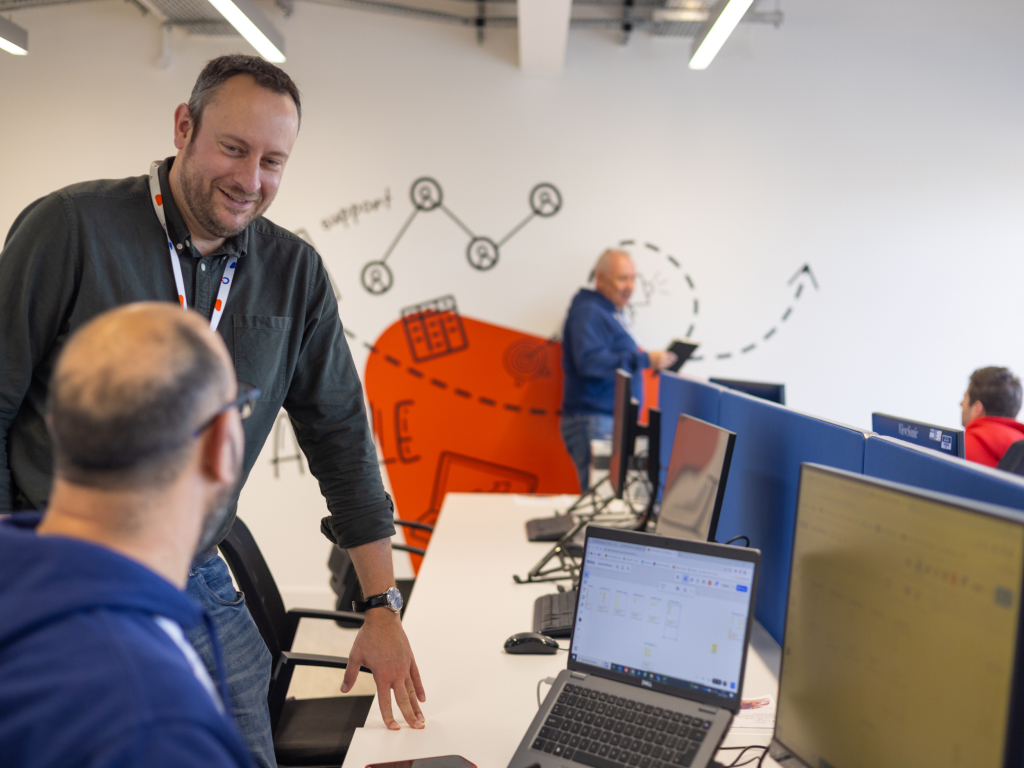 Men in front of a laptop.