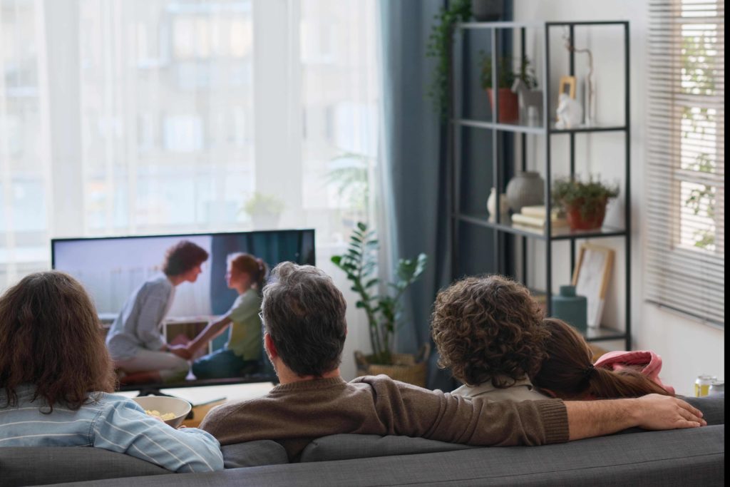 People watching a movie together on TV – blog article about launching cloud-based OTT services for broadcasters