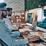 two men in front of computers
