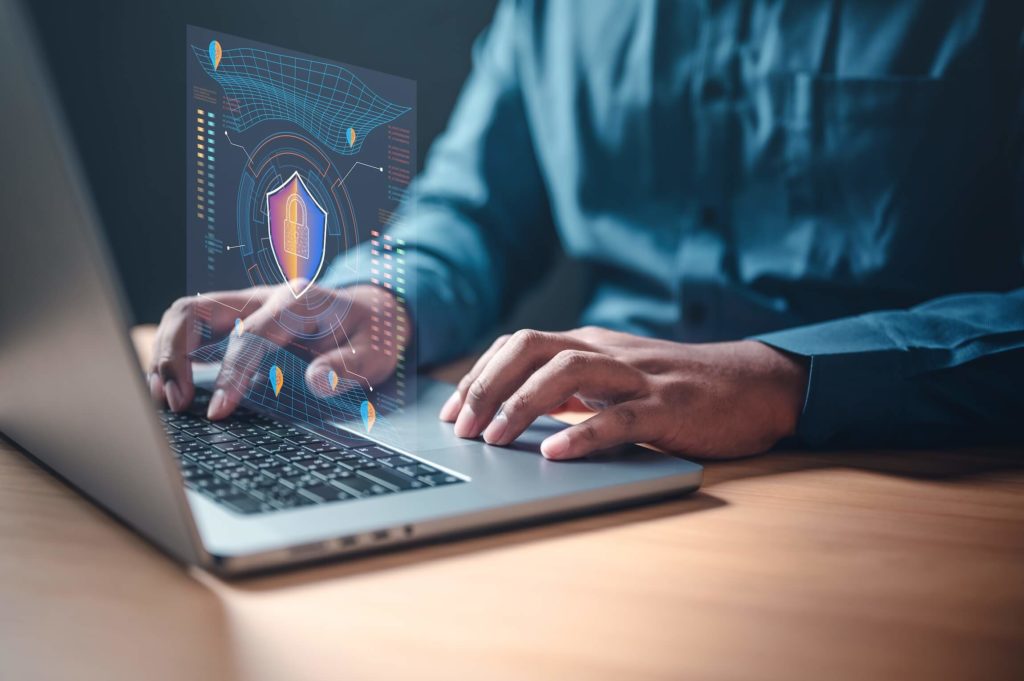 Industry 4.0 Most common IoT security issues and how to prevent them; image of a person typing on their laptop