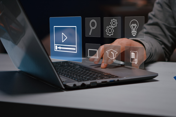 Publishers – person working on laptop with holographic icons representing video, search, and settings tools