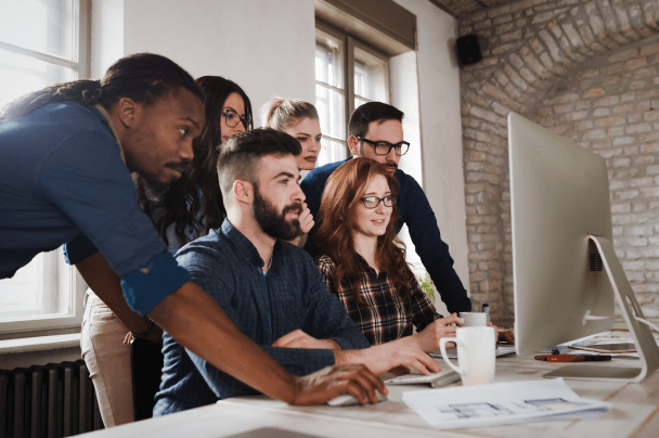 Group of developers collaborating on project – continuous improvement in OTT Managed Services operations