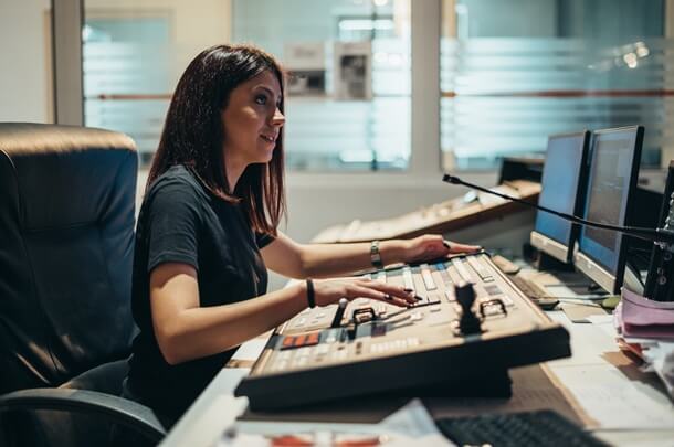 a woman sitting at a television console, broadcasters, signal management