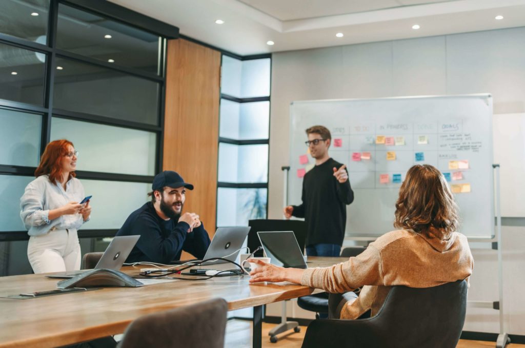 people sitting in the office discussing the value of the discovery phase in software development