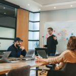 people sitting in the office discussing the value of the discovery phase in software development