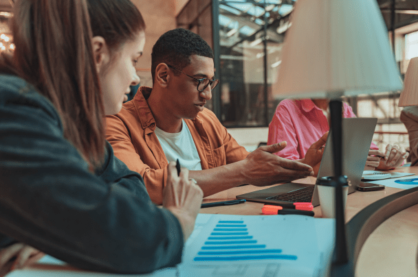 Content Creators – marketing team analysing charts and performance data in a meeting room