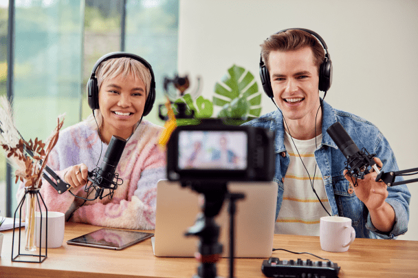 Content Creators – two young podcasters recording a video podcast with camera and microphones