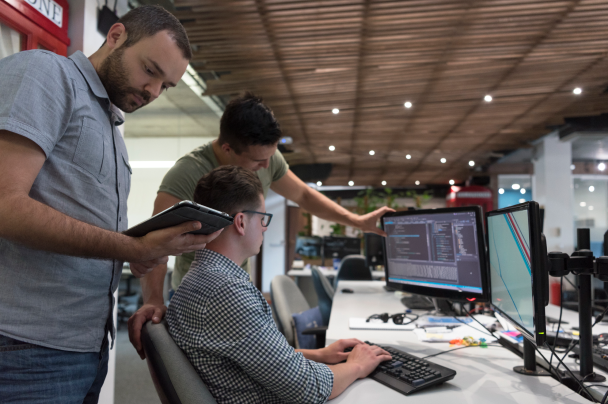 Telcos – development team collaborating on coding and testing telecom or media software solution