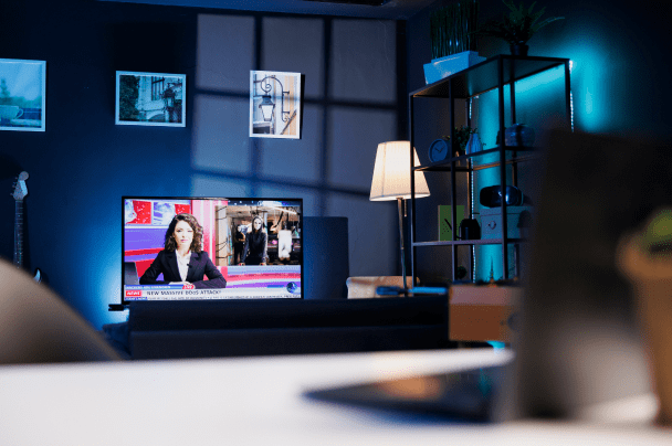 Event Organisers – TV screen showing news broadcast in a modern living room