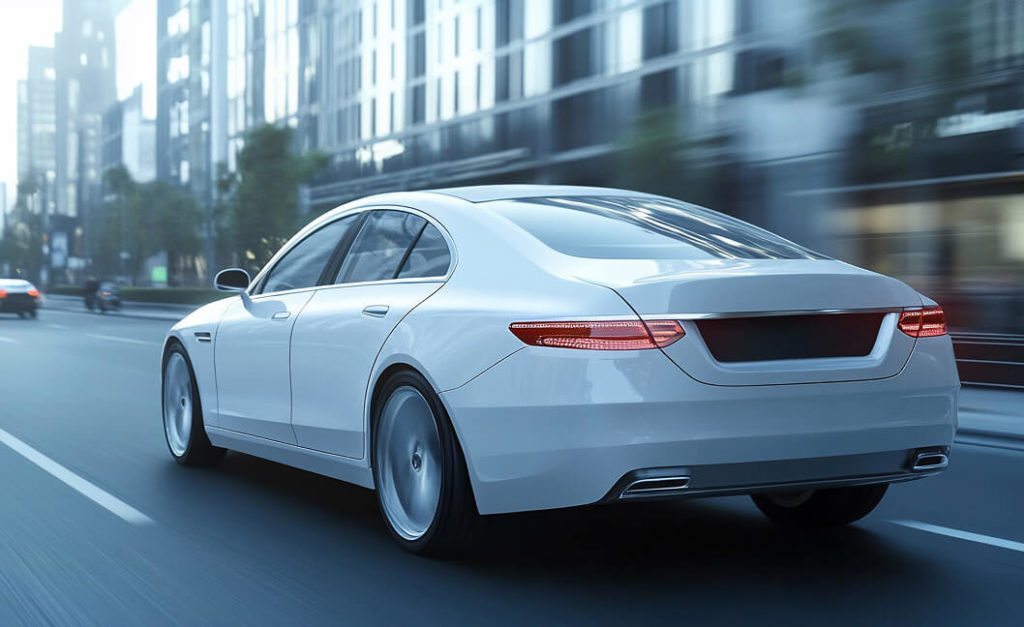 White car driving through city