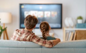 couple sitting in front of tv
