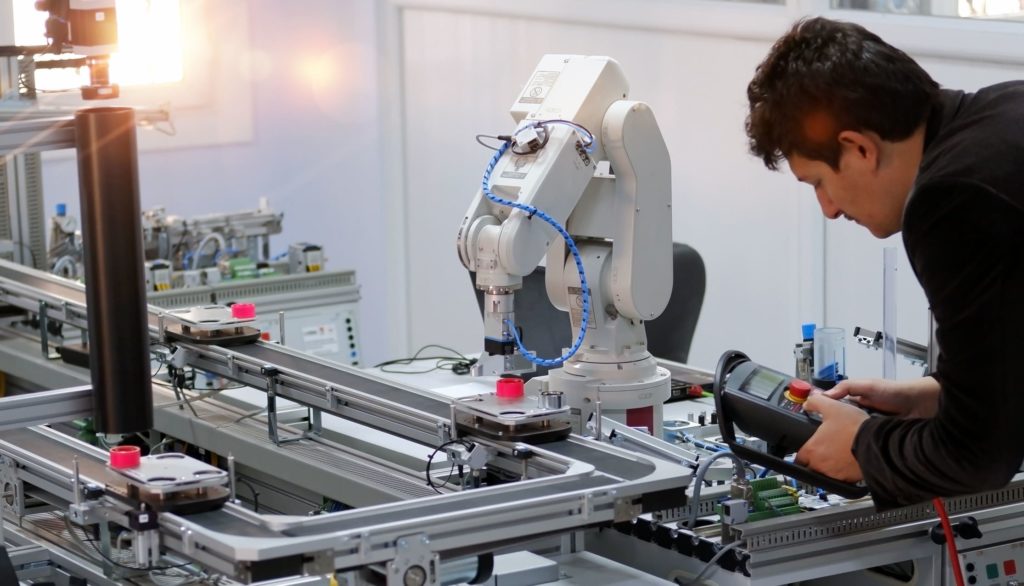 a man in a factory over a production line