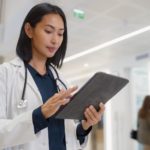 photo showing a doctor using a tablet