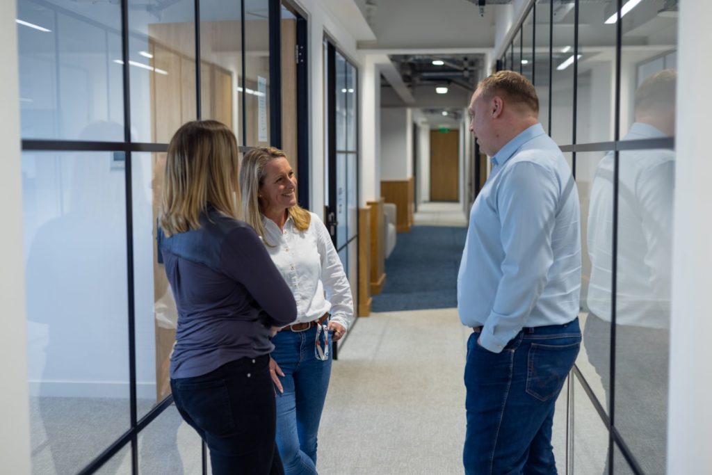 Spyrosoft's team of experts for software development in London chatting in the office