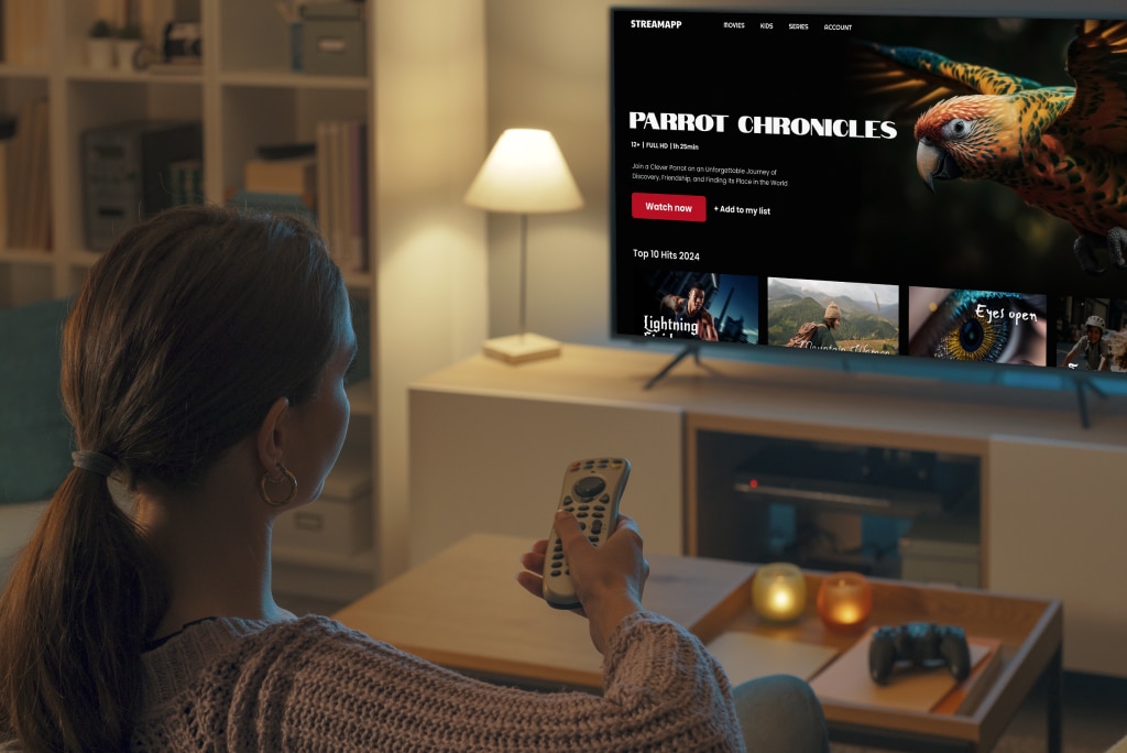 Woman using a streaming app on Smart TV – example of Connected TV App Framework for seamless viewing experience