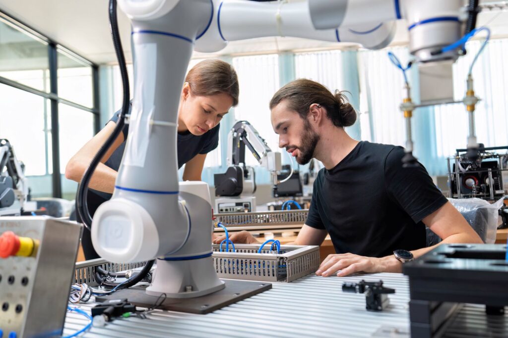 Robotics engineer in an R&D lab performs diagnostics on an AI-driven robot.
