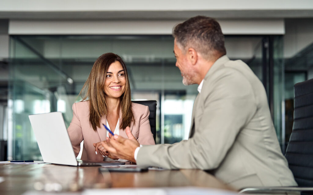 X Genie for Insurance. Happy businesswoman talking to a client