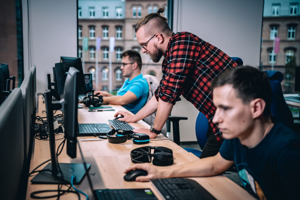 Spyrosoft employees working on computers in their office in Cracow