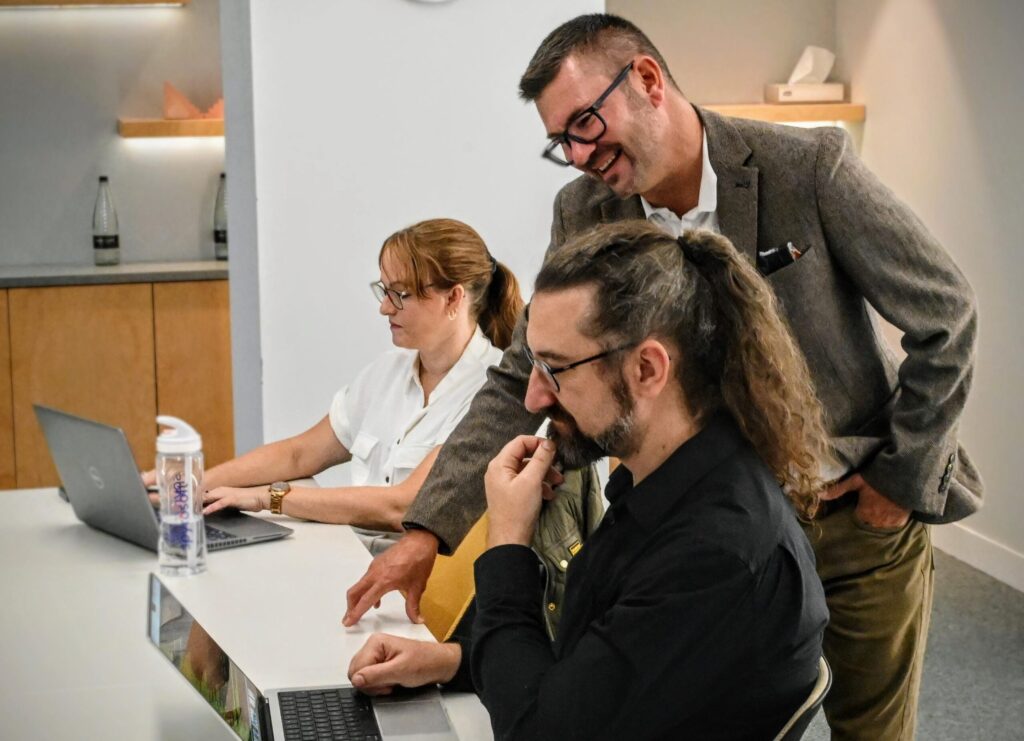 A group of people are thinking about solving a problem, they are in the Spyrosoft site in London