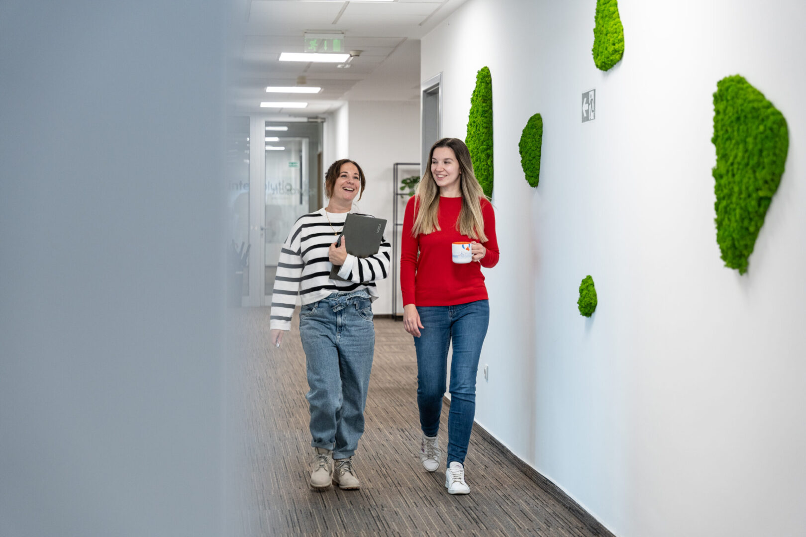 Two young women walk down the corridor at Spyrosoft's office in Zagreb.