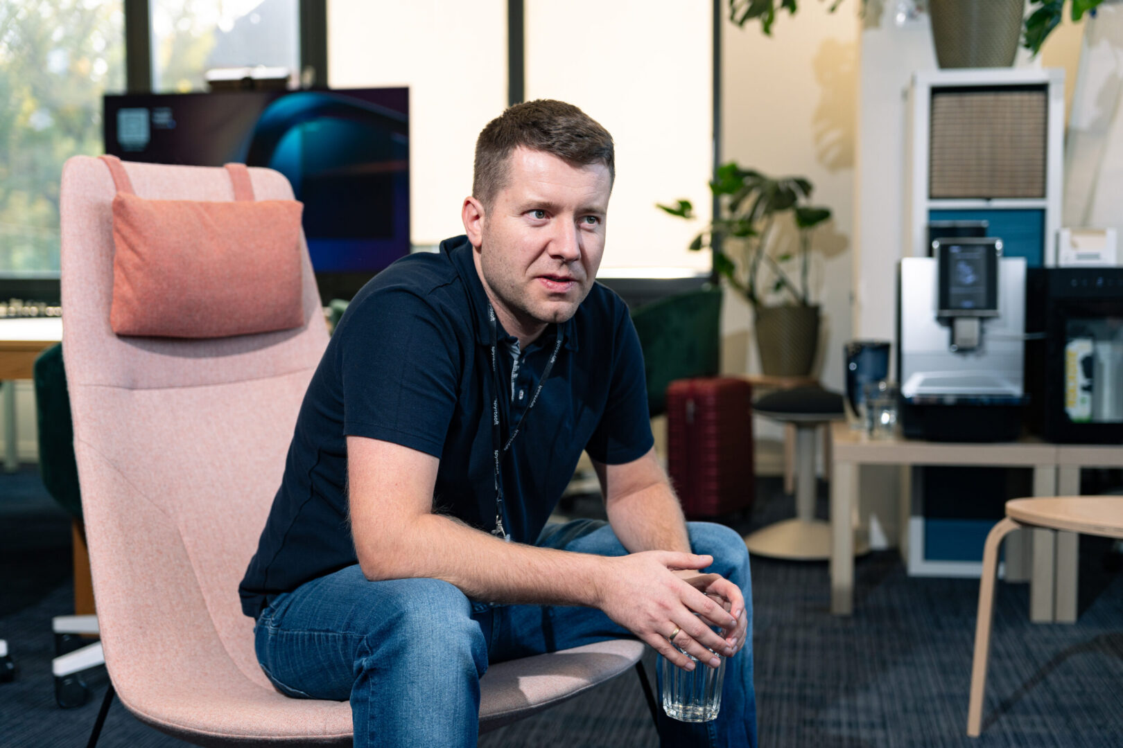 A man sits in a chair in the Spyrosoft Synergy office in Szczecin