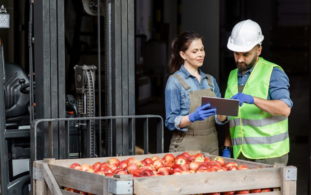 Agritech workers managing the supply chain and logistics of products in modern agricultural business